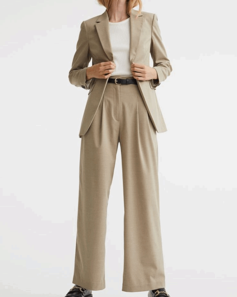 Woman wearing a beige wide-leg pantsuit with a white top — a flattering fit that highlights accurate body measurements and styling confidence.