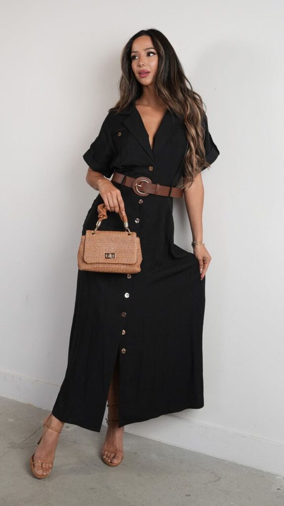 Woman in a black belted dress with neutral heels and a woven handbag, creating a polished and flattering look.