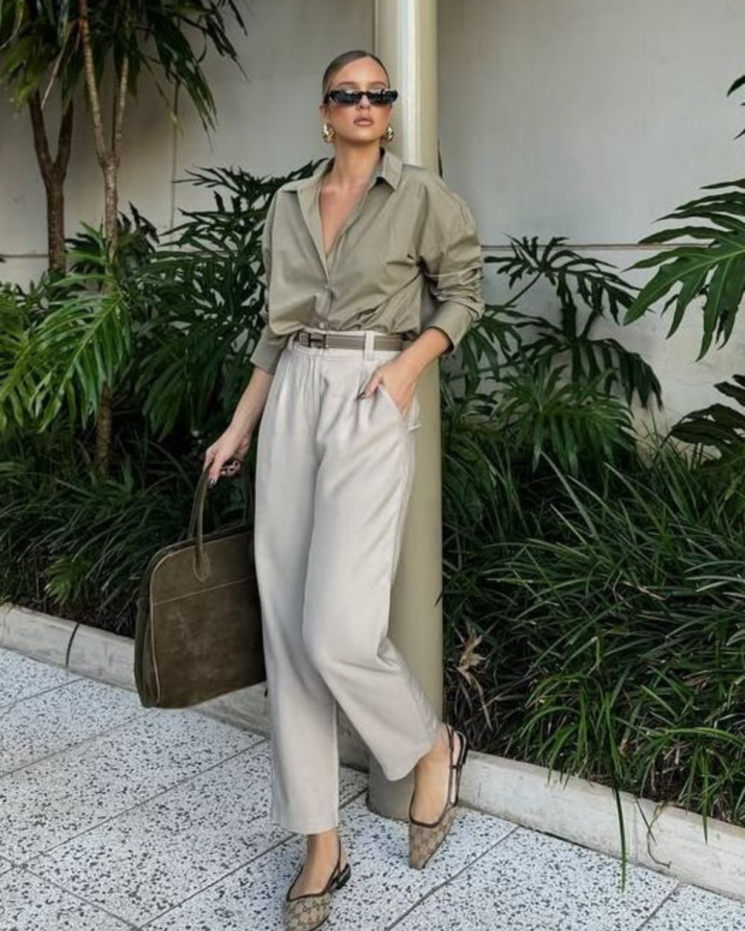 Woman wearing wide leg trousers and a structured blouse styled for a professional office look.